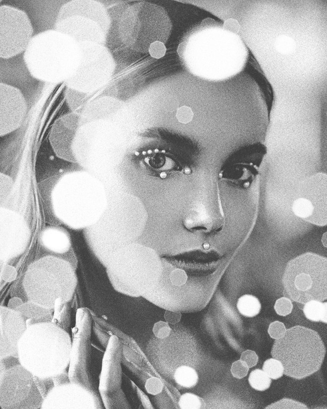 young woman with glitter pearls and bokeh